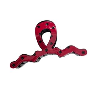 Polka dot red hair claw clip with irregular wave design for elegant hairstyling