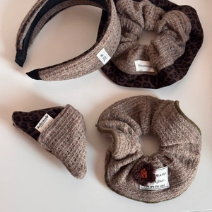 Close-up of handmade knit hair accessories set featuring leopard print and floral details