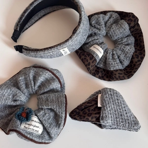 Detail view of large knit and leopard print hair scrunchies with retro cloth labels