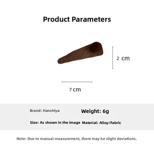 Detail view of brown fabric triangle hair clip with plush ball showing 7cm x 2cm size