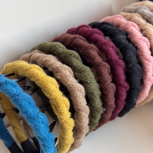 Close-up of cable knit headbands with anti-slip teeth in multiple vibrant colors