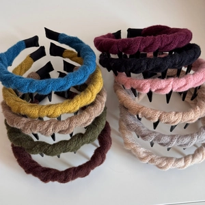Detailed close-up of colorful braided wool headbands with non-slip inner plastic teeth