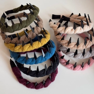 Detail of wool knitted headbands with punk rivets in multiple colors and anti-slip tips