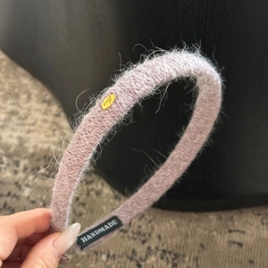 Détail du serre-tête en peluche lilas avec boucle dorée Love et étiquette Handmade