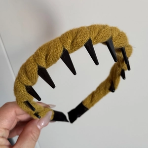 Detail of ginger yellow knitted headband showing anti-slip inner teeth and soft wool texture