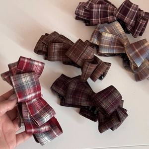 Elegant multi-layered plaid bow hair clips in various colors with black secure grips