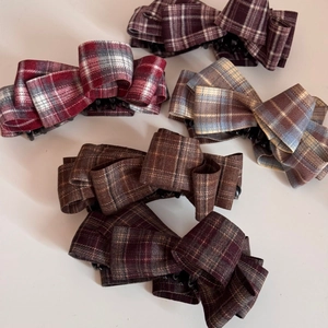 Detailed top view of five plaid fabric bow banana clips in multiple colors