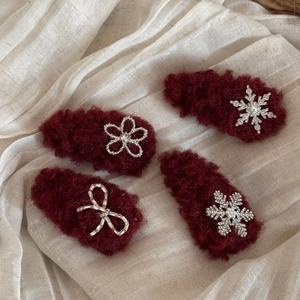 Set of four red plush hair clips with rhinestone flowers, snowflakes and bow accents