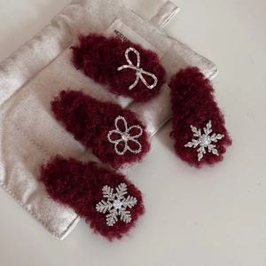 Detail view of 4-piece set of wine red plush flower hair clips with pearls and rhinestones