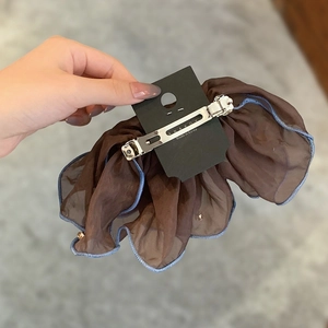 Detail of Korean tulle hair clip with blue edging and metal spring mechanism