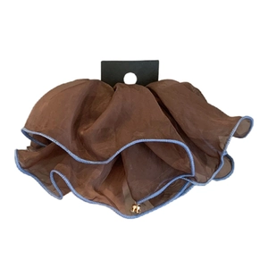 Brown organza hair scrunchie with blue trim and golden bell charm on display