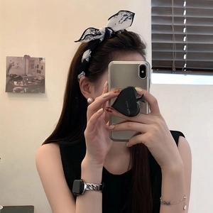 Close-up of a sweet rabbit ear floral bow headband with elegant white pearl earrings