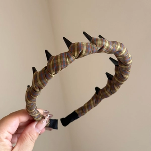 Detail of plaid fabric headband with black non-slip inner teeth for secure hair styling