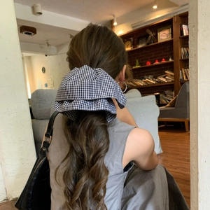 Elegant black and white gingham oversized bow hair scrunchie for long wavy hair styling