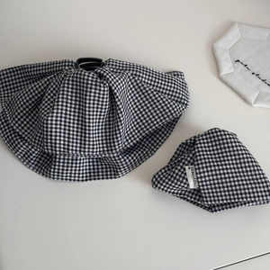 Chic black and white gingham fabric scrunchie set with happiness tag on gray surface