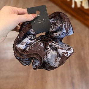 Blue and brown tie-dye oversized scrunchie for hair styling with marble pattern texture