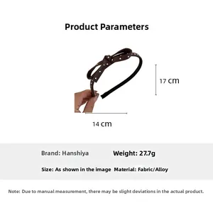 Polka dot bow headband with dimensions 14cm width and 17cm height in brown leather