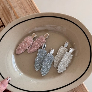 Sparkling crystal leaf-shaped hair clips set in pink, blue and clear stones