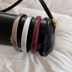 Set of four shiny faux leather headbands in silver, burgundy, black, and bronze tones