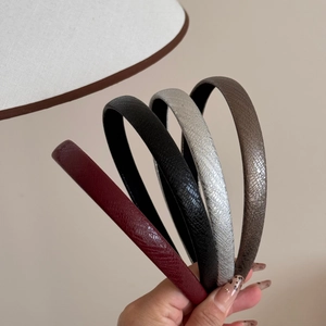Detailed view of four narrow leather headbands featuring unique cracked texture and vintage colors