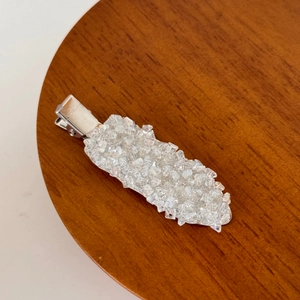 Close-up of sparkling crystals on a silver metal duckbill hair clip for styling