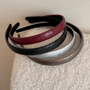 Set of four glossy snakeskin patterned faux leather headbands in burgundy black silver and brown