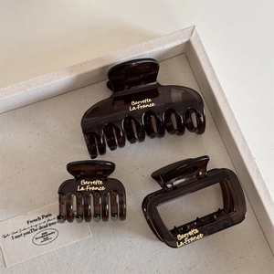 Three-piece set of deep brown tortoiseshell hair claws with gold Barrette La France lettering