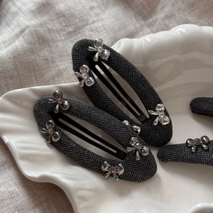 Elegant grey herringbone fabric hair clips with silver metal bow and crystal details