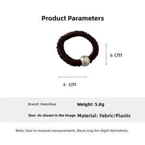 Detail of dark red pleated fabric hair tie with silver bead showing 6cm diameter size