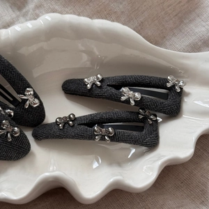 Gray herringbone fabric BB hair clip set with silver metal bow and rhinestone detail