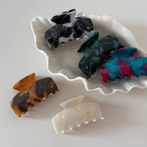 Detailed collection of marble and tortoiseshell acetate hair claws in various elegant textures