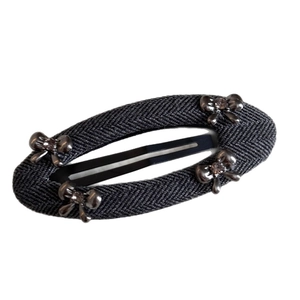 Elegant grey herringbone oval hair clip with metallic bows and rhinestone accents