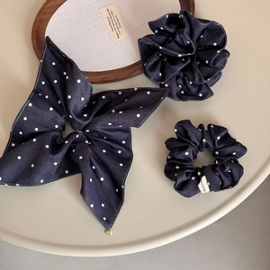 Three-piece navy blue polka dot scrunchie set with bow ribbon and handmade tag