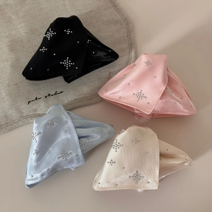 Flat lay of satin hair clips in four colors featuring sparkling star-shaped rhinestones