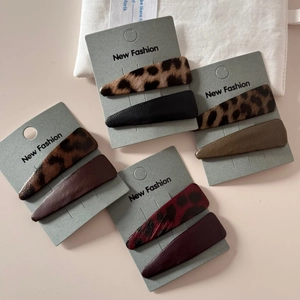 Detail showing assorted leopard print and solid leather triangle snap hair clips set
