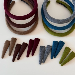 Close-up of wool texture on five minimalist autumn colored headbands and clips