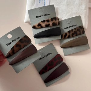 Set of leopard print and solid faux leather snap hair clips in multiple autumn colors