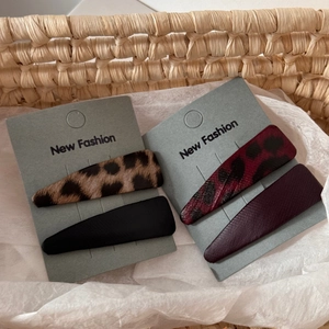 Set of four leopard print and matte leather triangle BB hair clips on display card