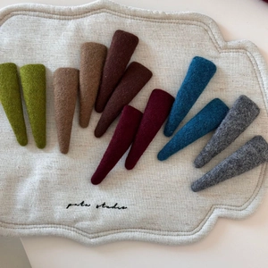 Detail view of colorful wool fabric hairbands with thick texture and minimal design
