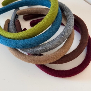 Detail showing various colors of thickened wool fabric headbands with soft plush texture