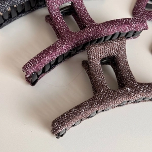 Detail of tweed fabric hair claws in deep purple and coffee brown colors