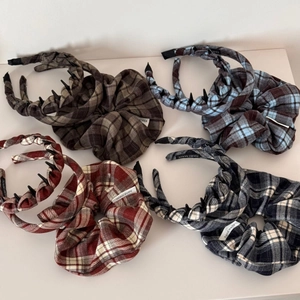 Detailed view of four brown checkered scrunchie headbands with non-slip inner teeth