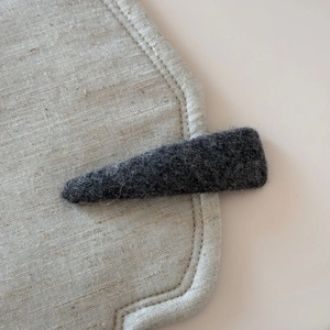 Close-up of minimalist dark grey wool felt headband texture and fine fiber details