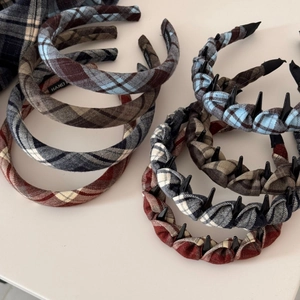 Close-up of brown plaid fabric headbands with fine stitching and nonslip inner teeth
