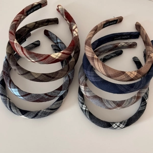 Detailed pile of handmade brown plaid scrunchies in soft fabric for women hair styling