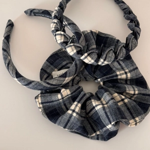 Detail of blue and white tartan fabric set including woven headband and scrunchie