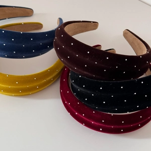 Close-up of velvet sponge headbands with sparkling rhinestones in multiple colors