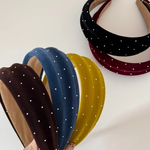 Macro shot of wide velvet headbands with sparkling rhinestones in five various colors