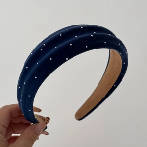 Detail of navy blue velvet padded headband with sparkling crystals for elegant hair styling
