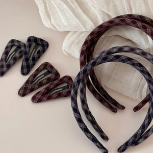 Detail of handmade vintage dark plaid wool hair clips and headbands in deep blue and burgundy